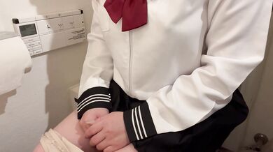 Her uniform skirt lifts while she finger fucks herself in the bathroom alone