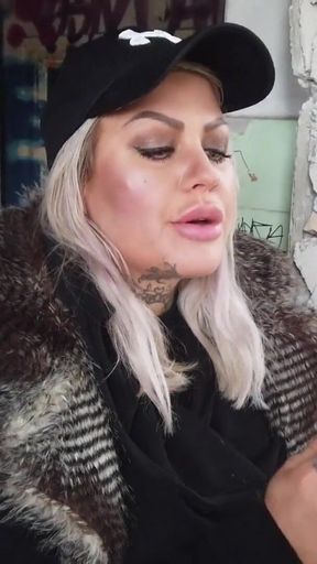 Blonde lady smokes an electronic cigarette