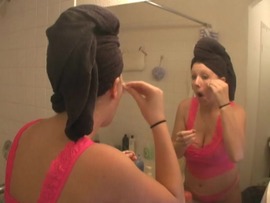 Ami Jordan applies make up in her bathroom