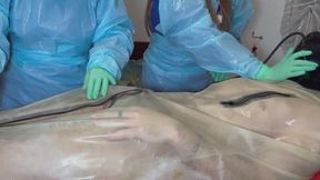 DOUBLE NURSES edge their rubber gimp wearing FULL PLASTIC PPE and minty coloured TIGHT latex gloves