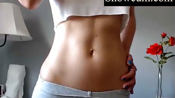 Gorgeous body teen slowly takes off her strap shirt while she is peeing down her gray leggings