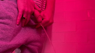 Guy pissing in the toilets of a bar