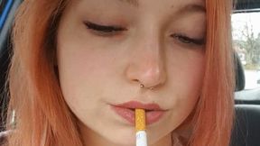 Sweet redhead smoking in car