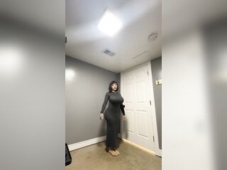Sexy trans CD in constricted gray suit teasing biggest dong