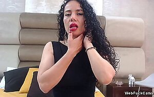 Curly dark haired MILF rubs shaved pussy on webcam