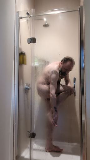 Chastity locked bear takes a ahower