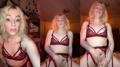 Blonde milf on her knees vibrating her clit in red garter lingerie