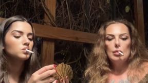 Stepmom and stepdaughter smoking and playing cards