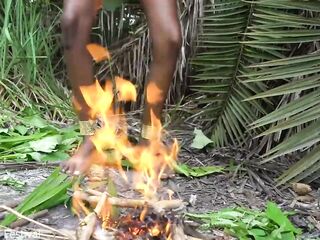 Hot African native woman cooking in the jungle