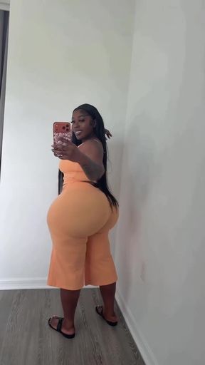 Curvy black woman in orange jumpsuit