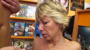 High heeled mature gets cum on tits while fucking in a dvd store