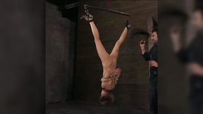Raunchy looking blonde nympho is hanging upside down in the dungeon