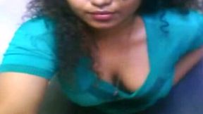 Curly amateur Indian brunette in blue T-shirt rubs her dark pussy