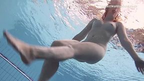 Redhead Lenka shows off her big tits and tight ass at the pool