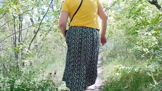 German MILF walking in the park showing off her charms under her skirt wanted to pee