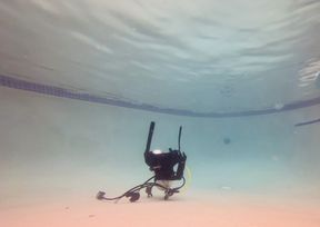 Carissa in mini sequin dress with gold heels in the pool with scuba