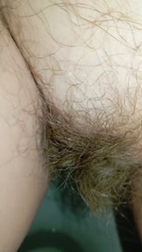 Bushy pussy girl peeing in the toilet with a sanitary pad in her panties