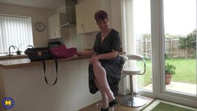 Busty redheaded GILF brings some new toys into her bedroom