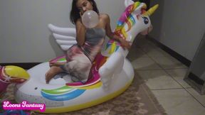 Akina blows up and pops her balloons on the unicorn