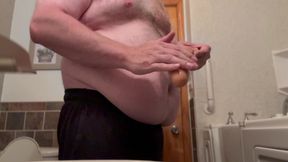 Fat Chub plays with dildo wearing a jock in his bathroom