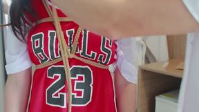 Girl in a basketball uniform with pigtails