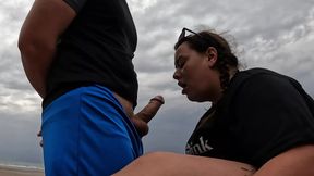 BBW gives risky blowjob on beach