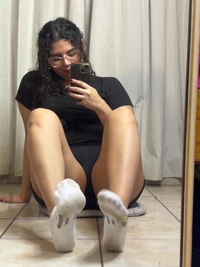 Woman sitting on floor with phone in hand