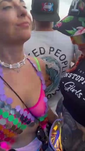 Amateur with tattoos shows off her tits at a public festival