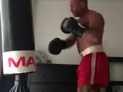 working the bag in red boxing trunks