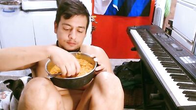 M a x x eats from a dog bowl in a dog collar