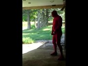 red zentai jerking off at garage door