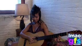 Watch Paul strip down to her petite frame and play with her shaved pussy with a guitar