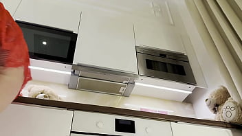 Sultry redhead strips and teases in the kitchen