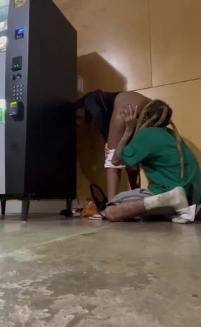 Insane public quickie by a black couple hiding behind a vending machine