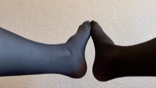 Sexy legs and feet in black nylon pantyhose