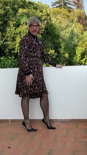 On my terrace in a dress and heel.