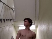 Solo teen plays with buttplug in the stairwell
