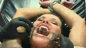 Bald headed dude teases fixed immobilized Katja Kassin's pussy in BDSM way