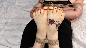 Ballgagged barefoot Amanda in black bra and skirt, hogtied on the bed, is spanked and tickled by a man (HD MP4)