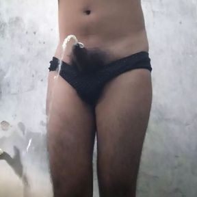 Teen Indian boy wearing black panty while pissing in the bathroom