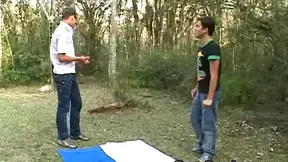 Outdoor gay blowjob by a guy in sunglasses with a dildo in his ass