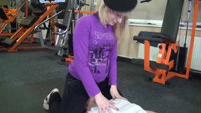 Blonde slut with glasses and her slave in gym