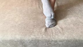 Gloria Gimson strokes her sexy feet in gray socks