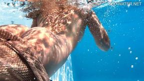 Eyla Moore, a famous model, glides elegantly through the water