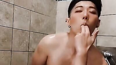 Horny Asian college jock plays with dildo in risky public shower