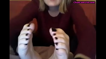 webcam model in sweatshirt suck her own toes