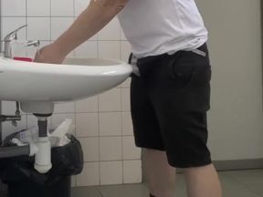 Guy Taking a Urine Sample in Hospital Toilets