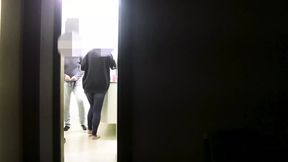 She gives a blowjob to her friend while her husband watches a series on TV.