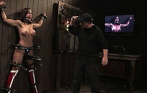 Busty Wunder Woman bound to the wall