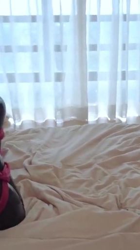 Mz15 - a Puppy Wearing a Latex Suit and Bound by a Red Rope.